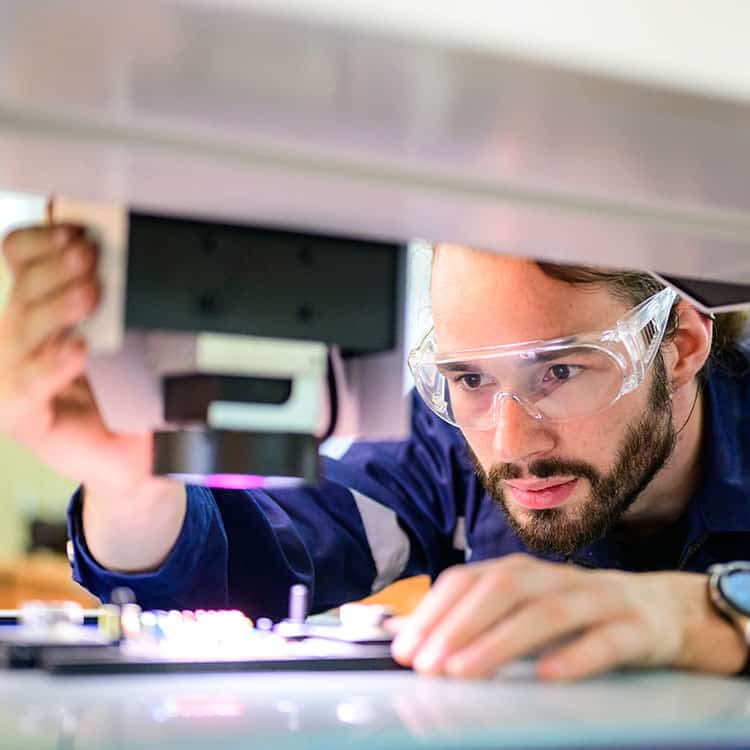 Engineer servicing laser system for maintenance