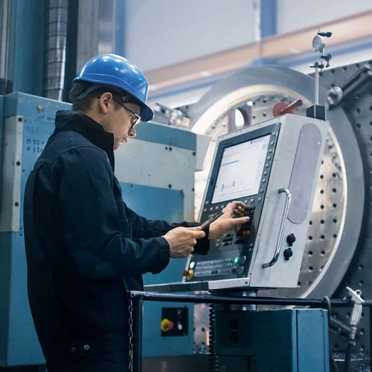 An engineer performing service maintenance on a machine